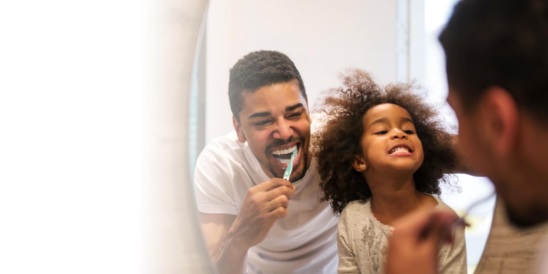 Parent and child brushing their