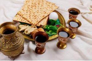 seder dinner with wine, greens, eggs, and matzah